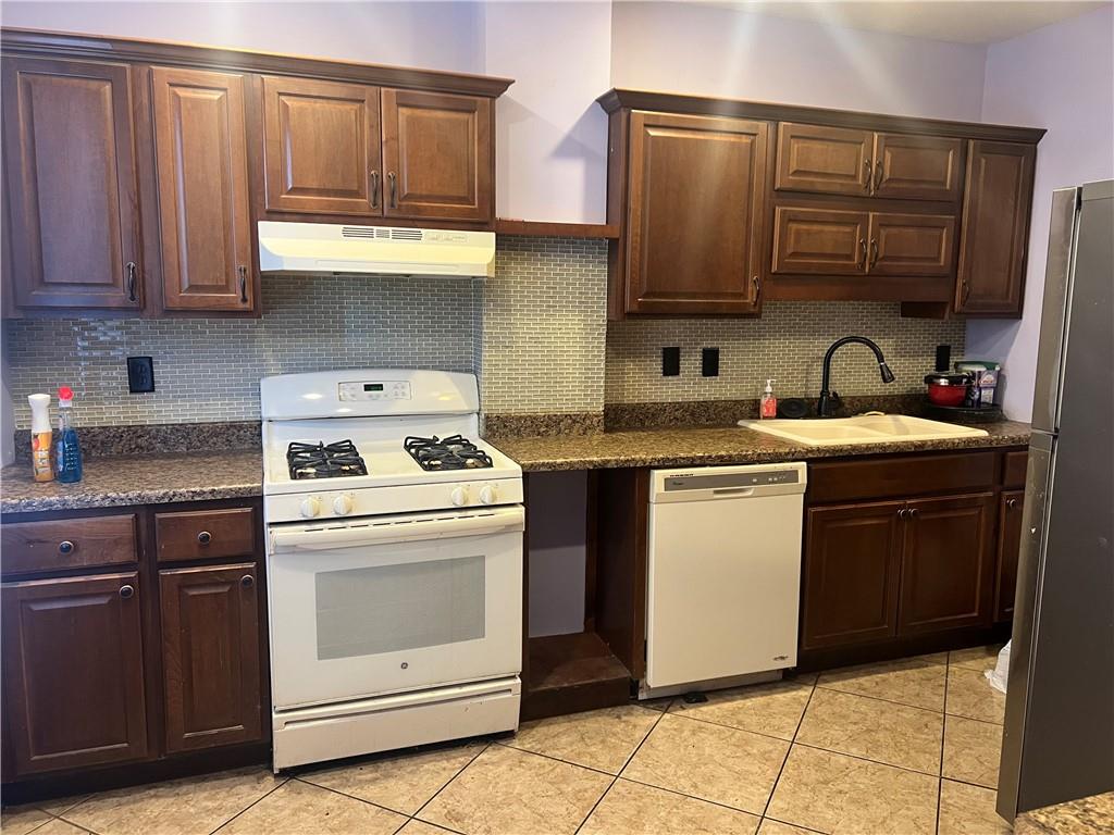 153 Locust Street Ambridge, PA 15003 - Photo 5 of 19 a kitchen with stainless steel appliances granite countertop a stove a sink and a microwave
