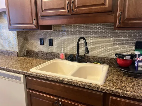 a bathroom with a granite countertop sink and a granite counter top