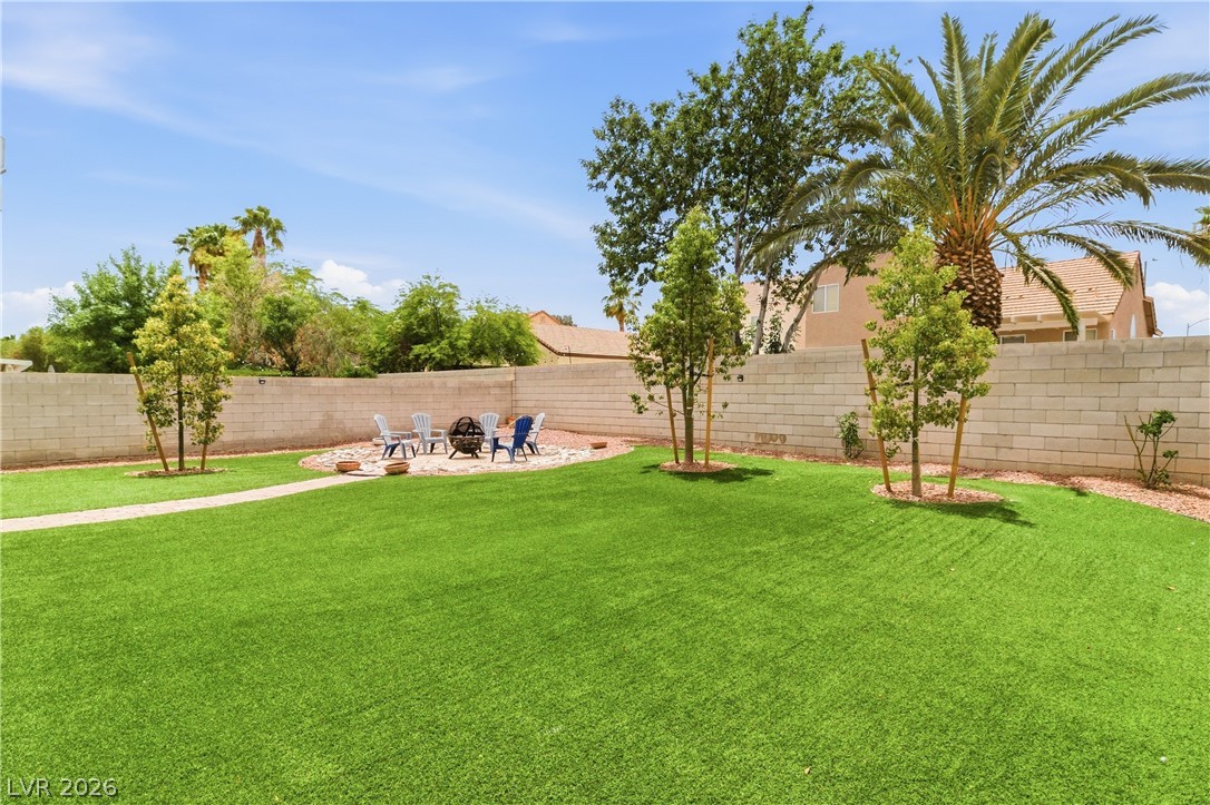 9523 Observer Street Las Vegas, NV 89123 - Photo 36 of 42 Green yard provides a lovely outdoor area for relaxation and entertaining, complete with a fire pit.