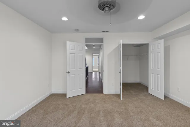 an empty room with closet and a bathroom