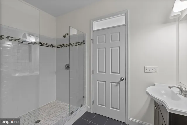 a bathroom with a shower and a sink