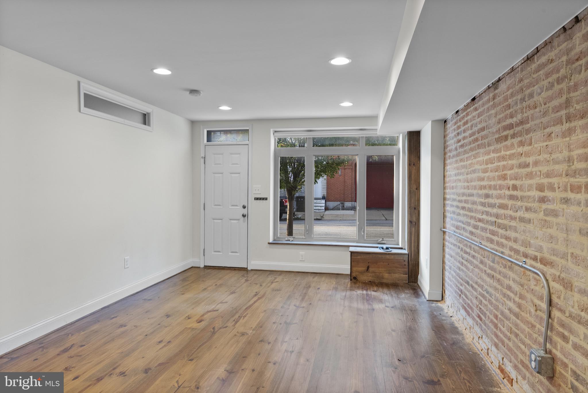 402 East Fort Avenue Baltimore, MD 21230 - Photo 19 of 35 a view of a hallway with wooden floor and a living room