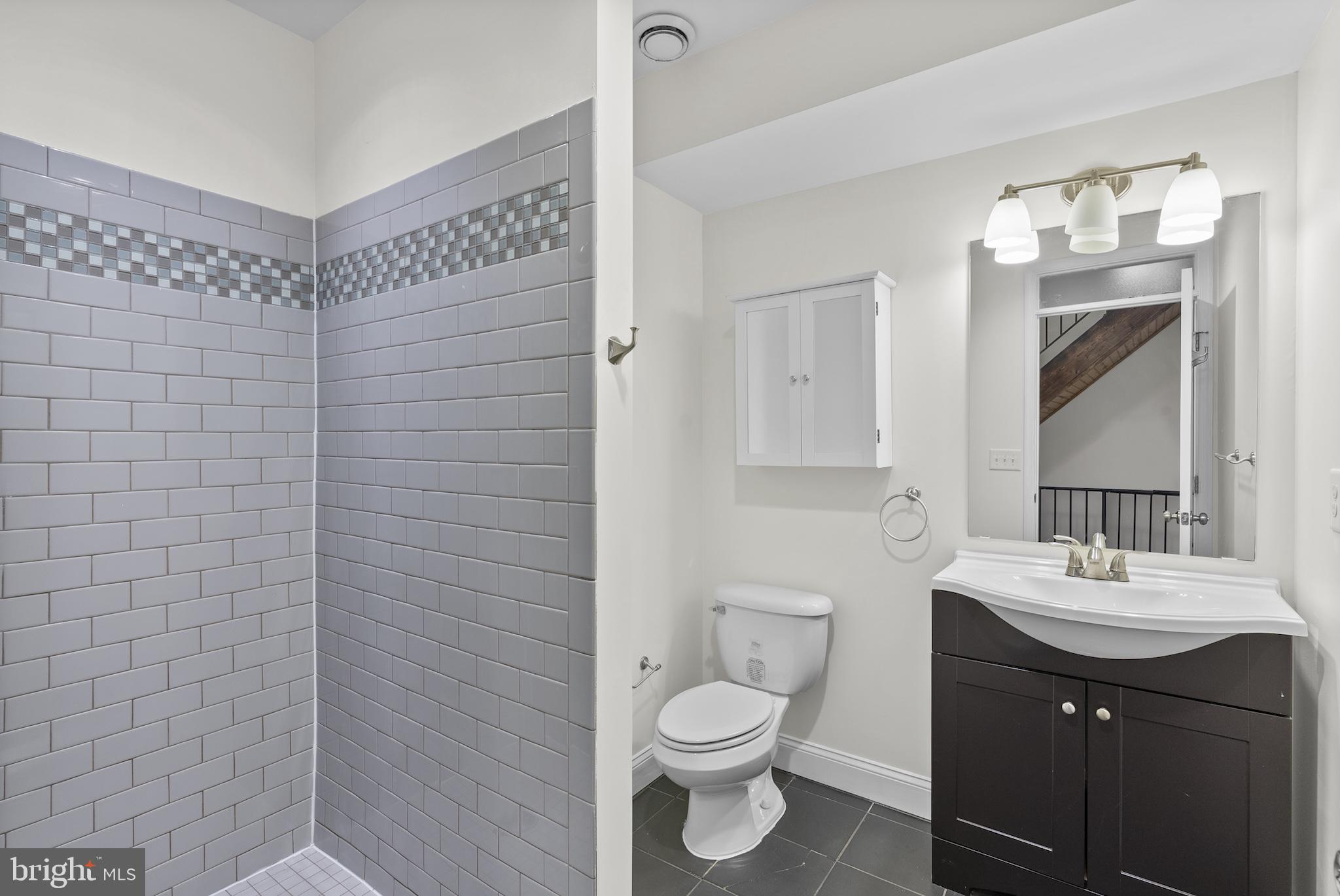 402 East Fort Avenue Baltimore, MD 21230 - Photo 23 of 35 a bathroom with a sink mirror vanity and toilet