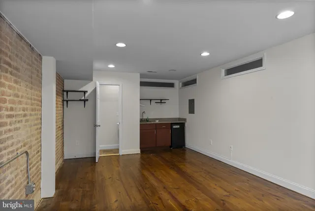 a view of a kitchen with a sink and a refrigerator
