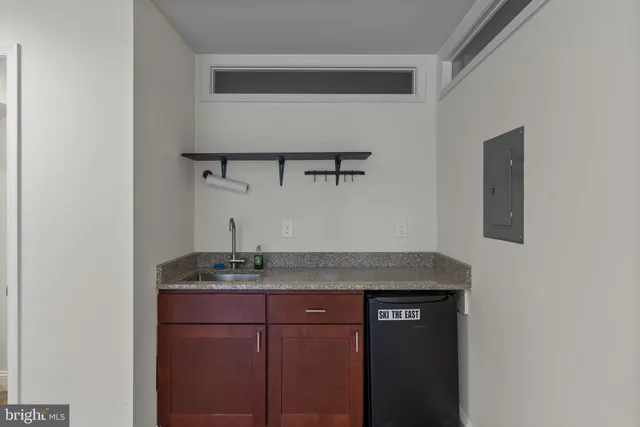a bathroom with a granite countertop sink and vanity