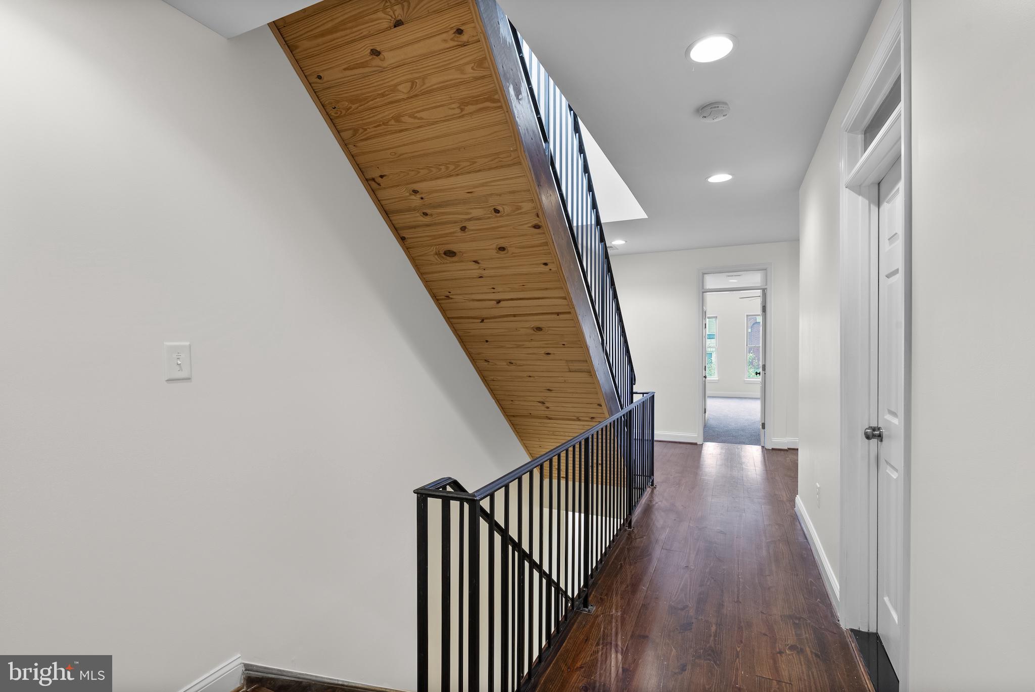 402 East Fort Avenue Baltimore, MD 21230 - Photo 8 of 35 a view of a hallway with wooden floor and staircase