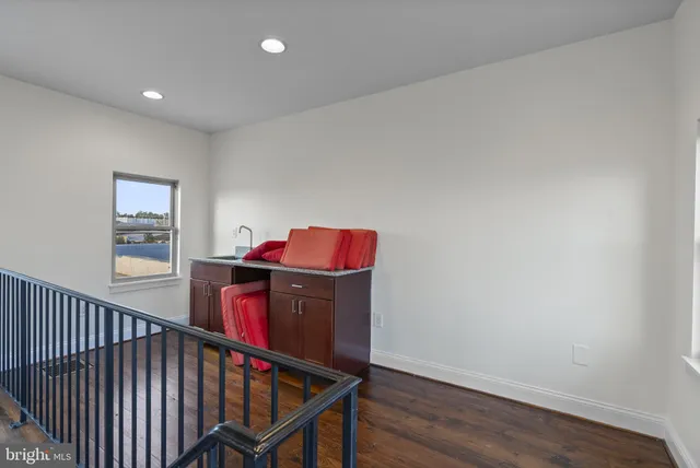 a balcony with wooden floor and furniture