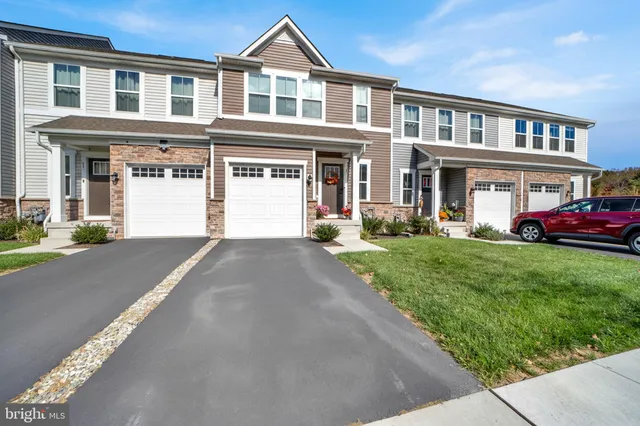 a front view of a house with a yard and porch