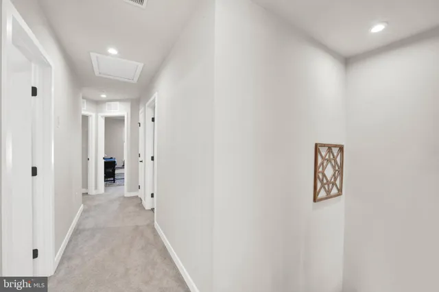 a view of a hallway with wooden shelves