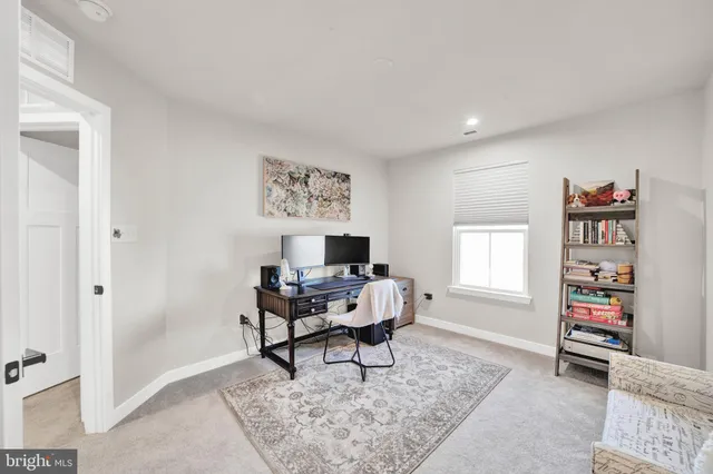 a living room with furniture a window and a bookshelf