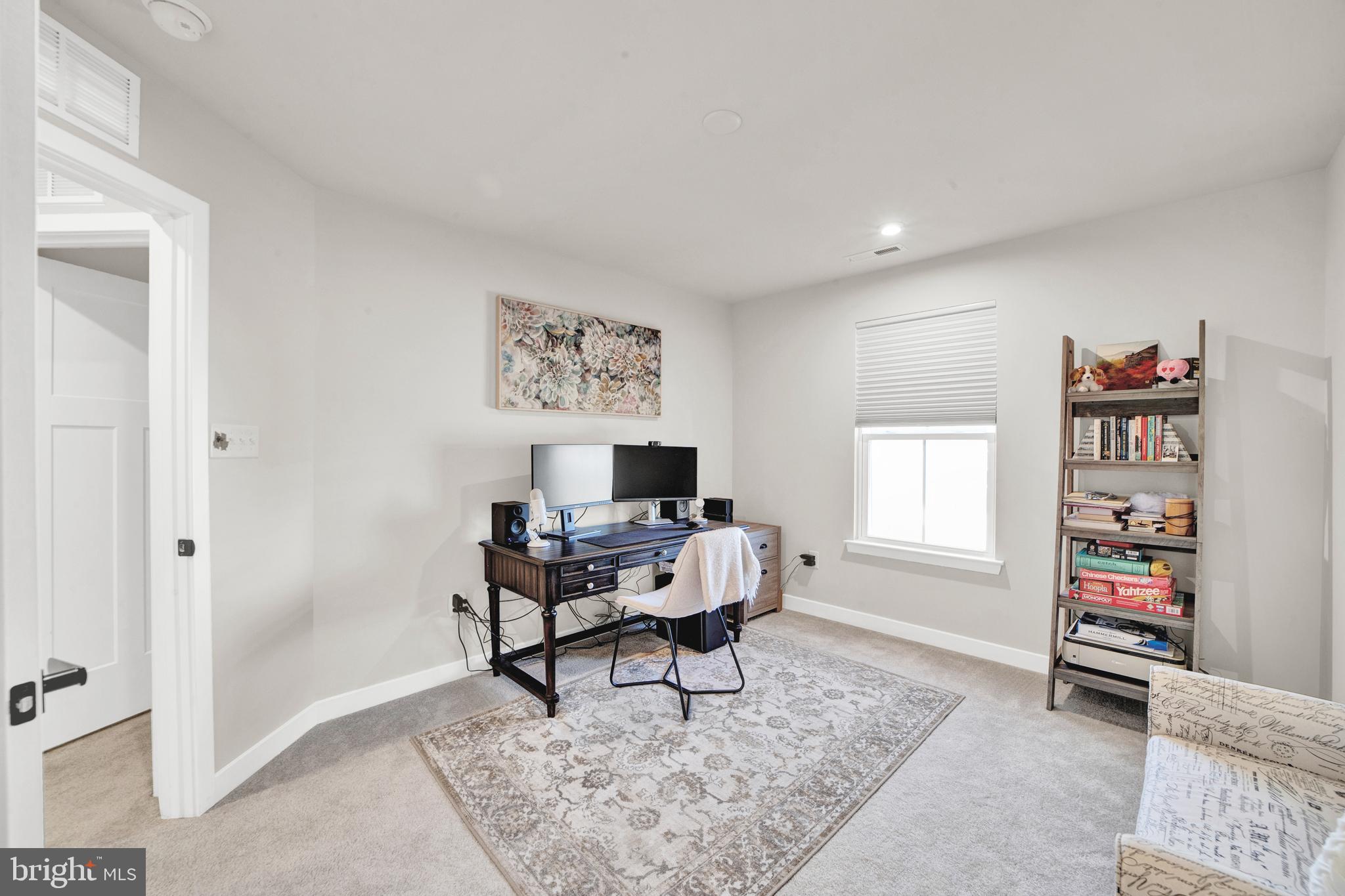 15 Pratt Lane Lawrence Township, NJ 08648 - Photo 20 of 31 a living room with furniture a window and a bookshelf