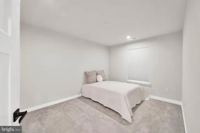 a bedroom with a bed and a night stand