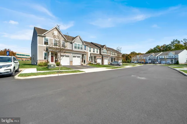 a view of multiple houses with a street