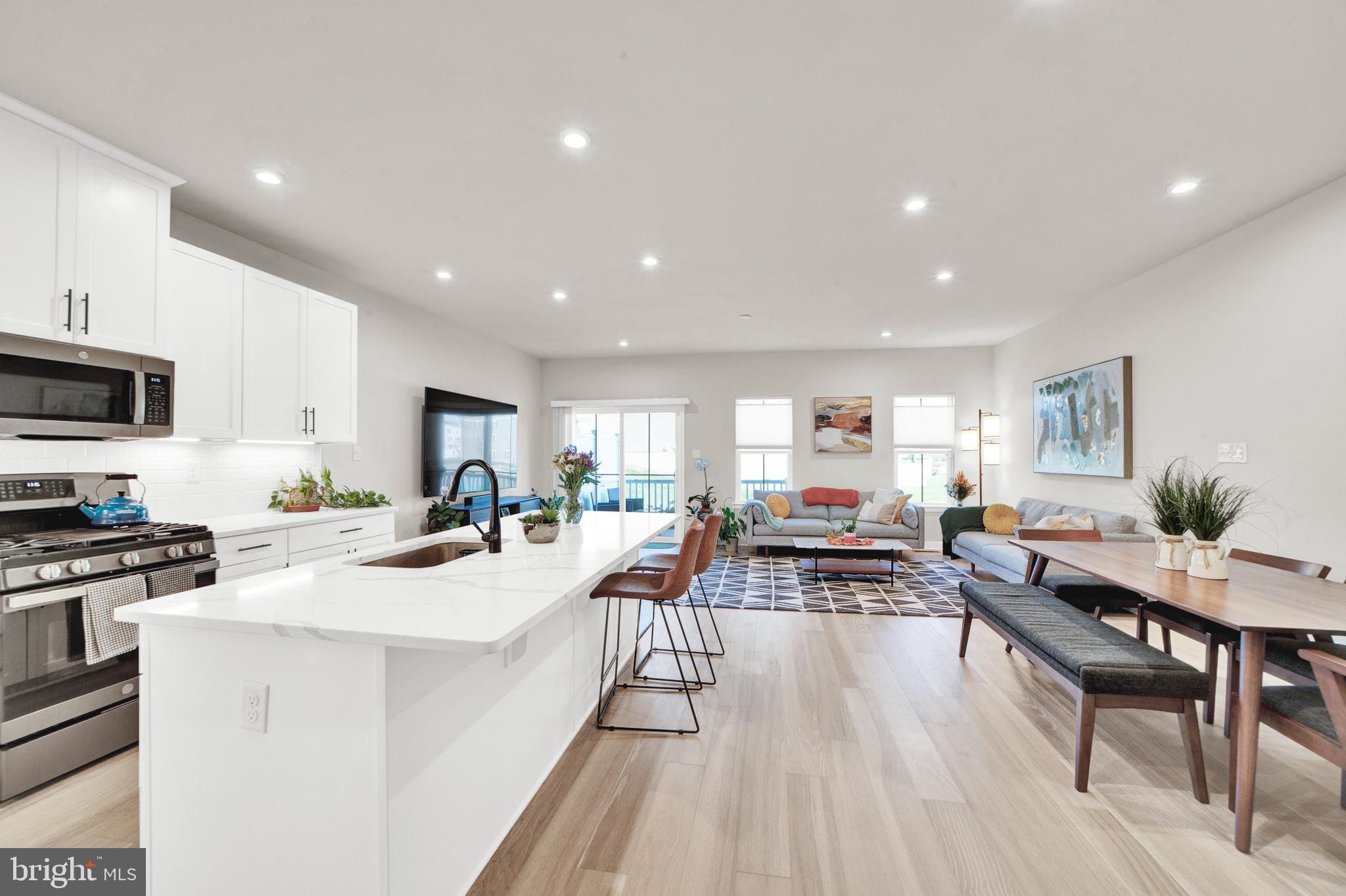 15 Pratt Lane Lawrence Township, NJ 08648 - Photo 6 of 31 a view of a kitchen with kitchen island a large counter top space a center island stainless steel appliances and a dining table view