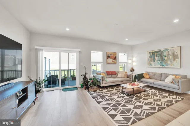 a living room with furniture large window and a fireplace