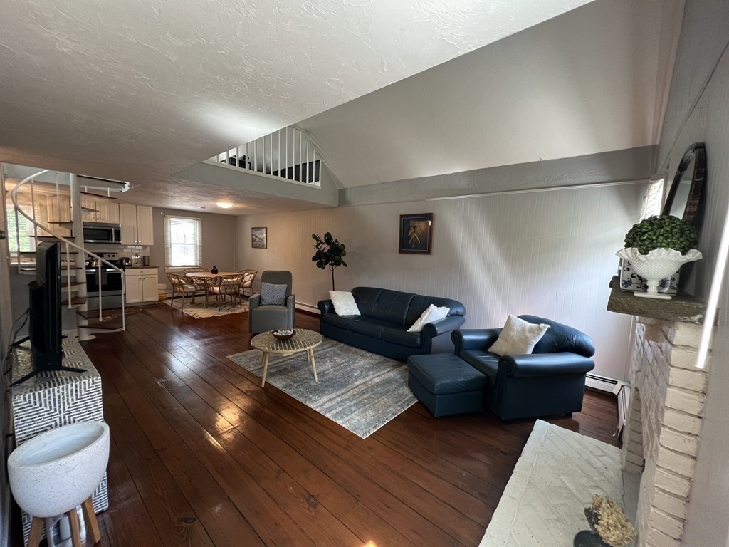 12 State Road, Unit 2E Plymouth, MA 02360 - Photo 8 of 28 a living room with lots of furniture and kitchen view