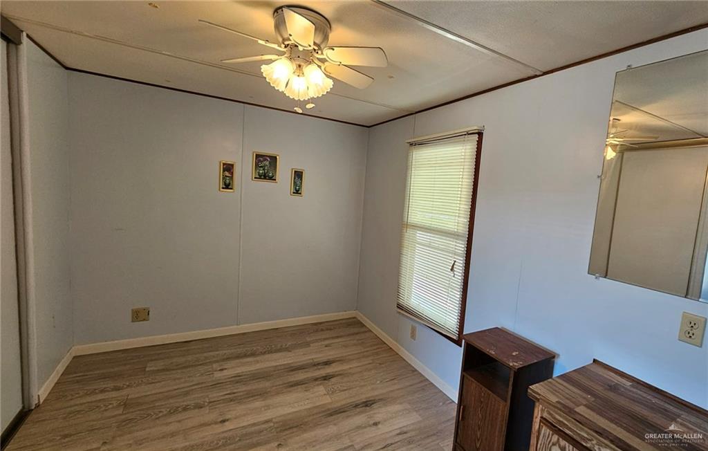 1905 Johnson Street Mission, TX 78572 - Photo 14 of 22 an empty room with wooden floor fan and windows