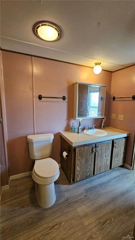 1905 Johnson Street Mission, TX 78572 - Photo 15 of 22 a bathroom with a granite countertop toilet sink and mirror