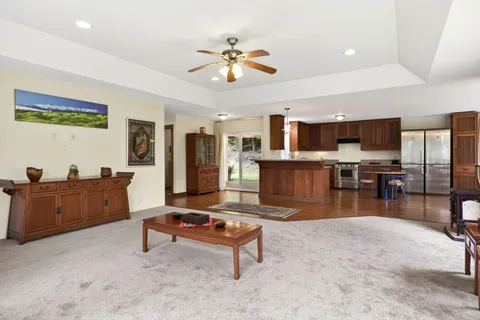 a living room with furniture and kitchen view