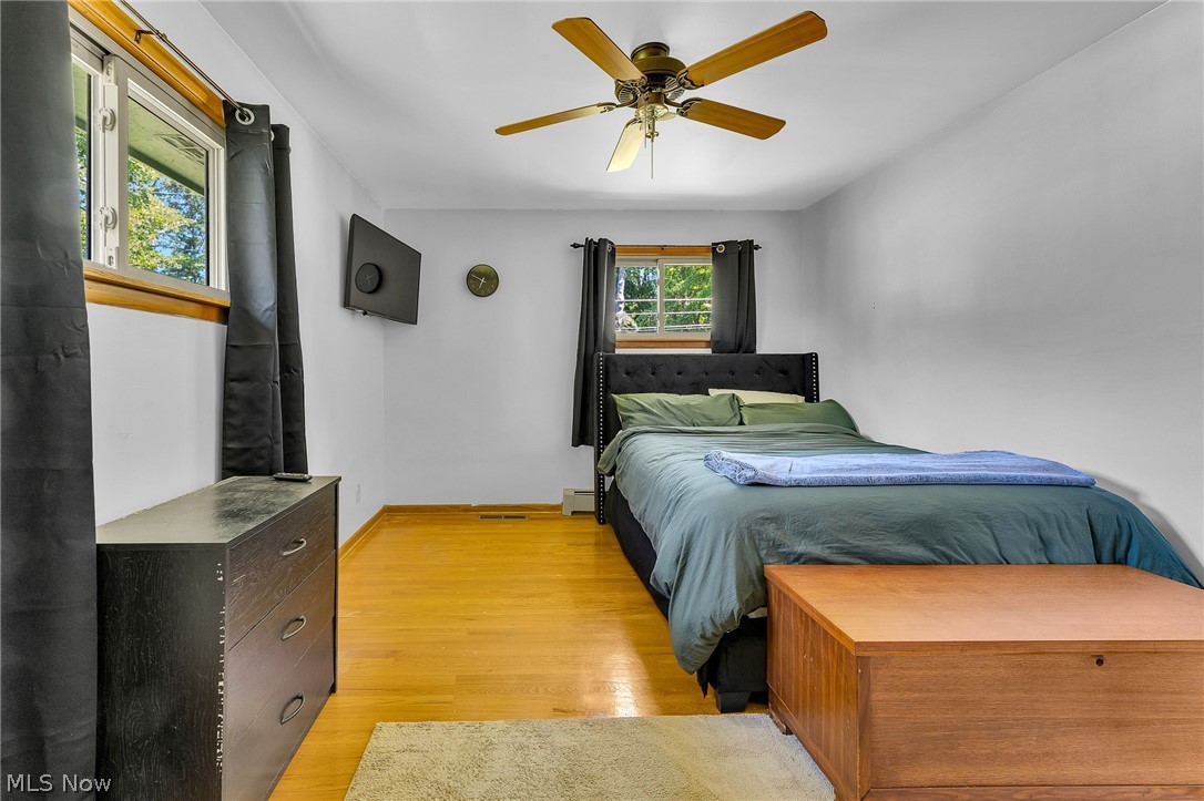 4685 New Road Youngstown, OH 44515 - Photo 20 of 37 Bedroom featuring ceiling fan, light hardwood / wood-style flooring, and baseboard heating