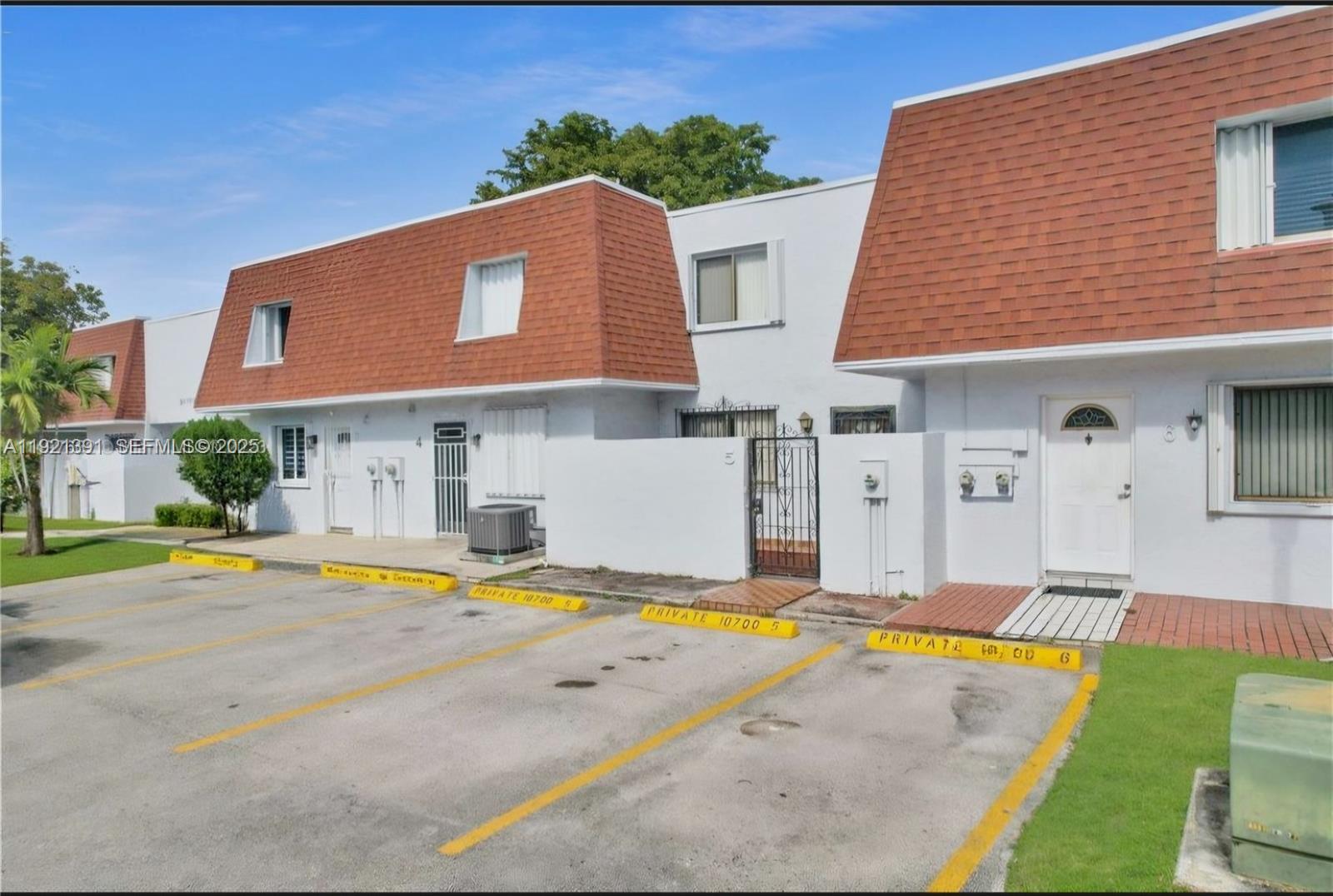 10700 Northwest 7th Street, Unit 5A Miami, FL 33172 - Photo 1 of 20 a view of a house with swimming pool and a yard