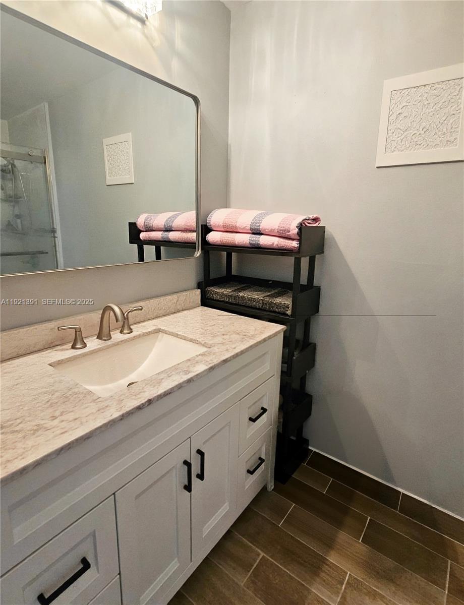 10700 Northwest 7th Street, Unit 5A Miami, FL 33172 - Photo 14 of 20 a bathroom with a sink and a mirror