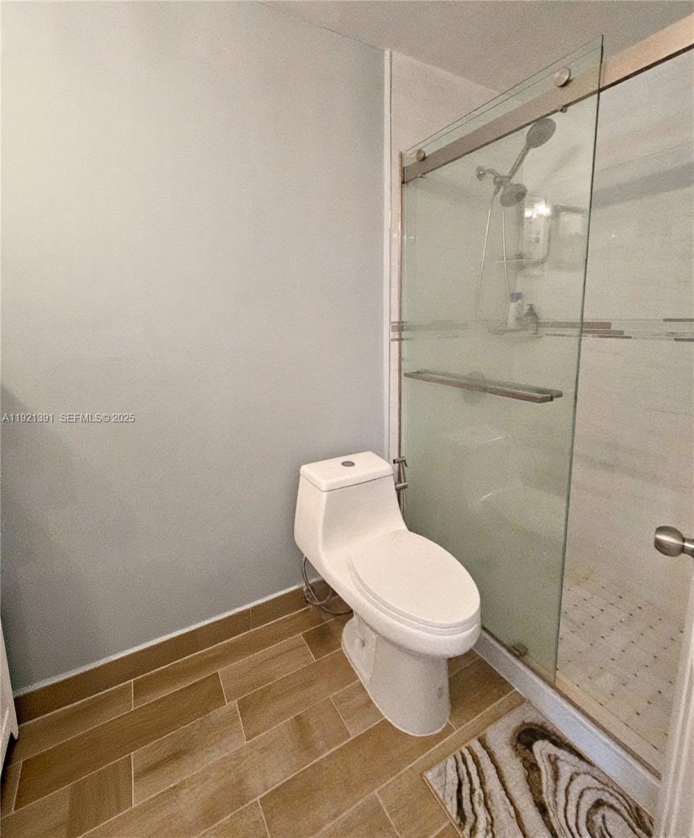 10700 Northwest 7th Street, Unit 5A Miami, FL 33172 - Photo 15 of 20 a bathroom with a toilet and a shower