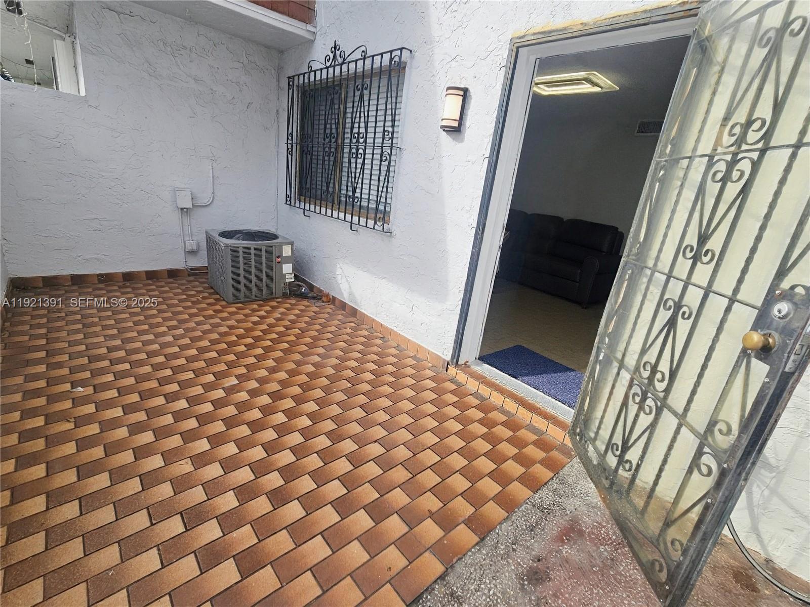 10700 Northwest 7th Street, Unit 5A Miami, FL 33172 - Photo 2 of 20 a bedroom with a bed and a mirror