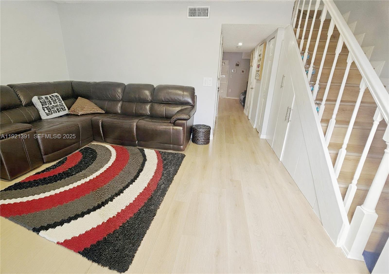 10700 Northwest 7th Street, Unit 5A Miami, FL 33172 - Photo 3 of 20 a living room with a couch and a rug
