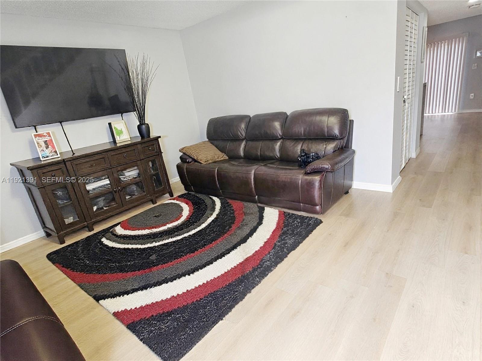 10700 Northwest 7th Street, Unit 5A Miami, FL 33172 - Photo 4 of 20 a living room with furniture and a rug
