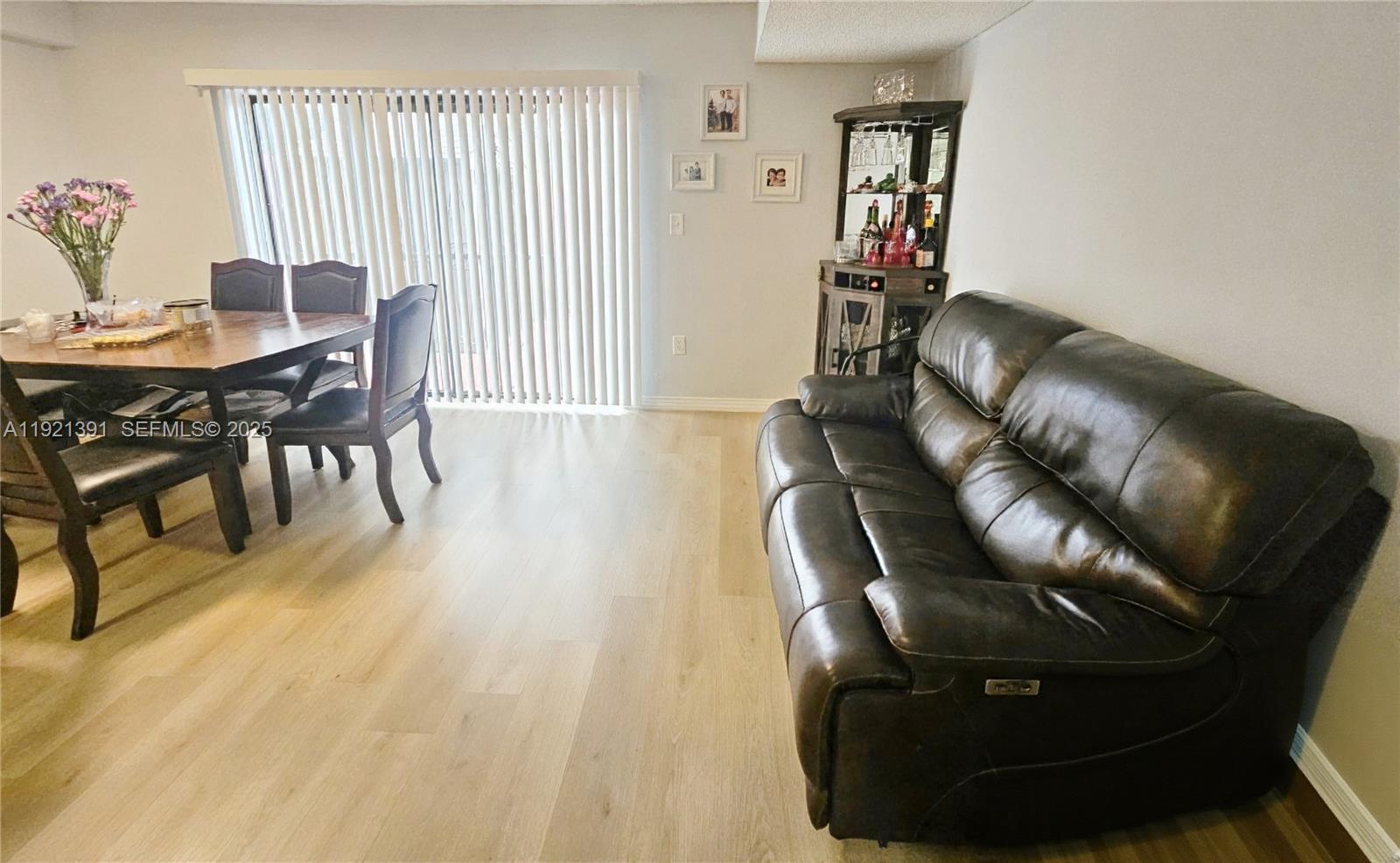10700 Northwest 7th Street, Unit 5A Miami, FL 33172 - Photo 5 of 20 a living room with furniture and wooden floor