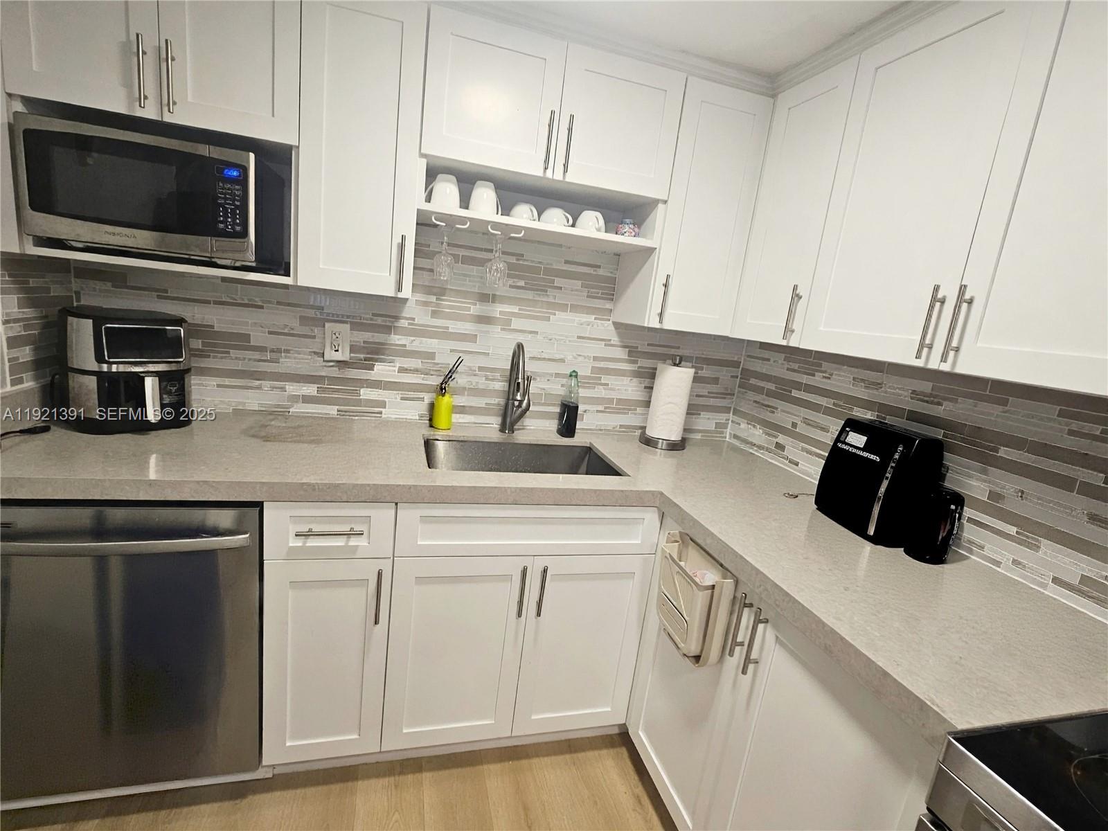 10700 Northwest 7th Street, Unit 5A Miami, FL 33172 - Photo 8 of 20 a kitchen with a sink and cabinets