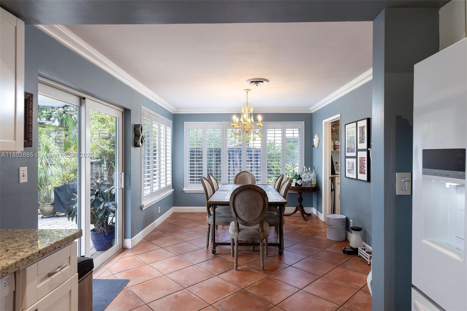 3192 Coolidge Street Hollywood, FL 33021 - Photo 13 of 34 a living room with furniture a fireplace and a floor to ceiling window