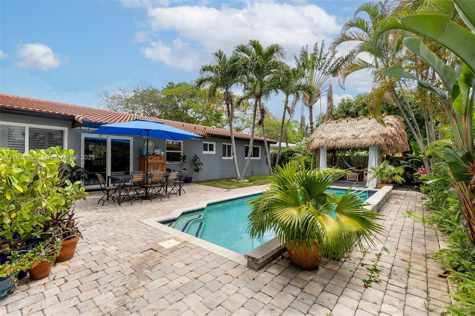 3192 Coolidge Street Hollywood, FL 33021 - Photo 15 of 34 a view of a house with swimming pool and sitting area