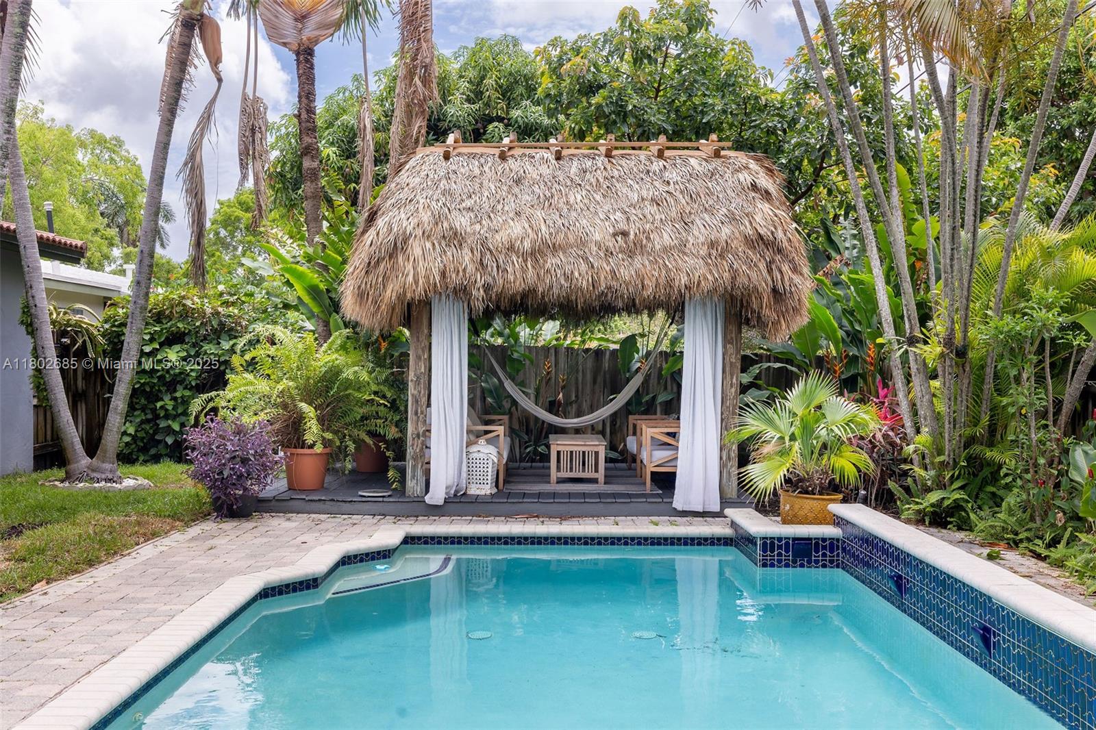 3192 Coolidge Street Hollywood, FL 33021 - Photo 18 of 34 a house with swimming pool in front of it