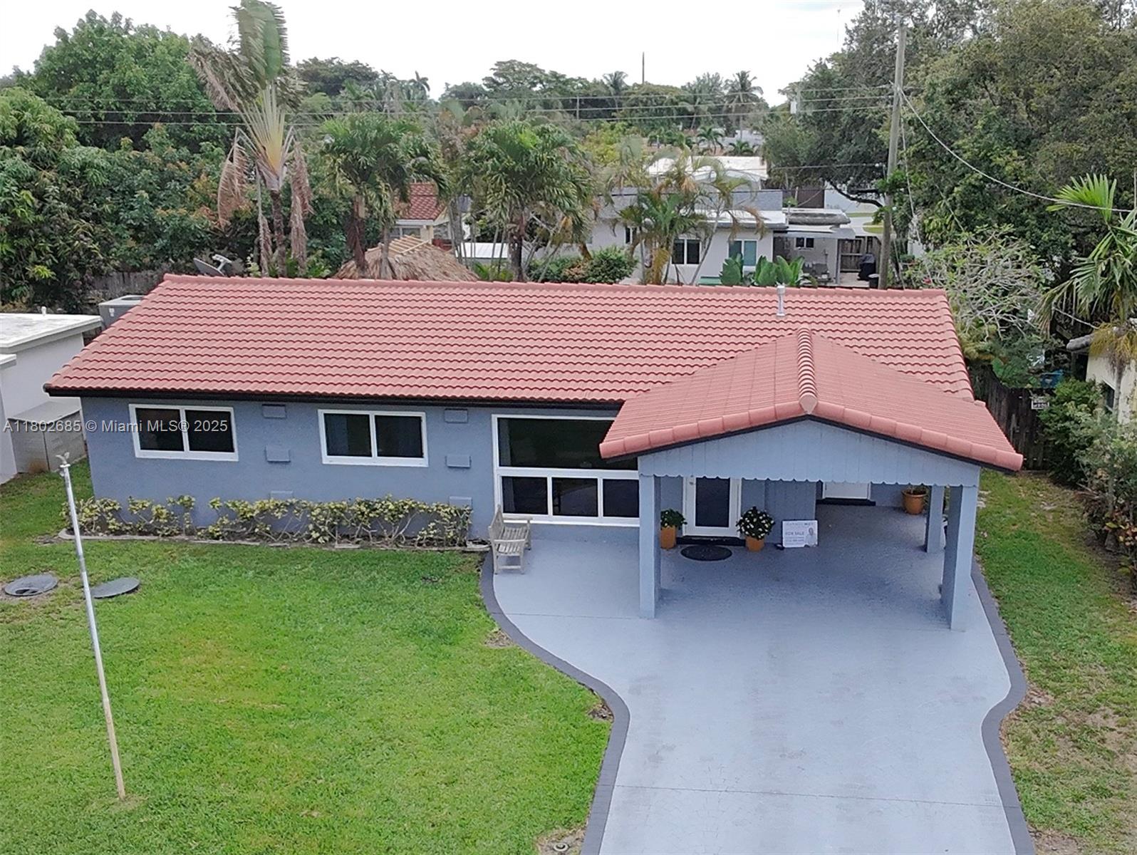 3192 Coolidge Street Hollywood, FL 33021 - Photo 25 of 34 a view of a house with a backyard and a patio
