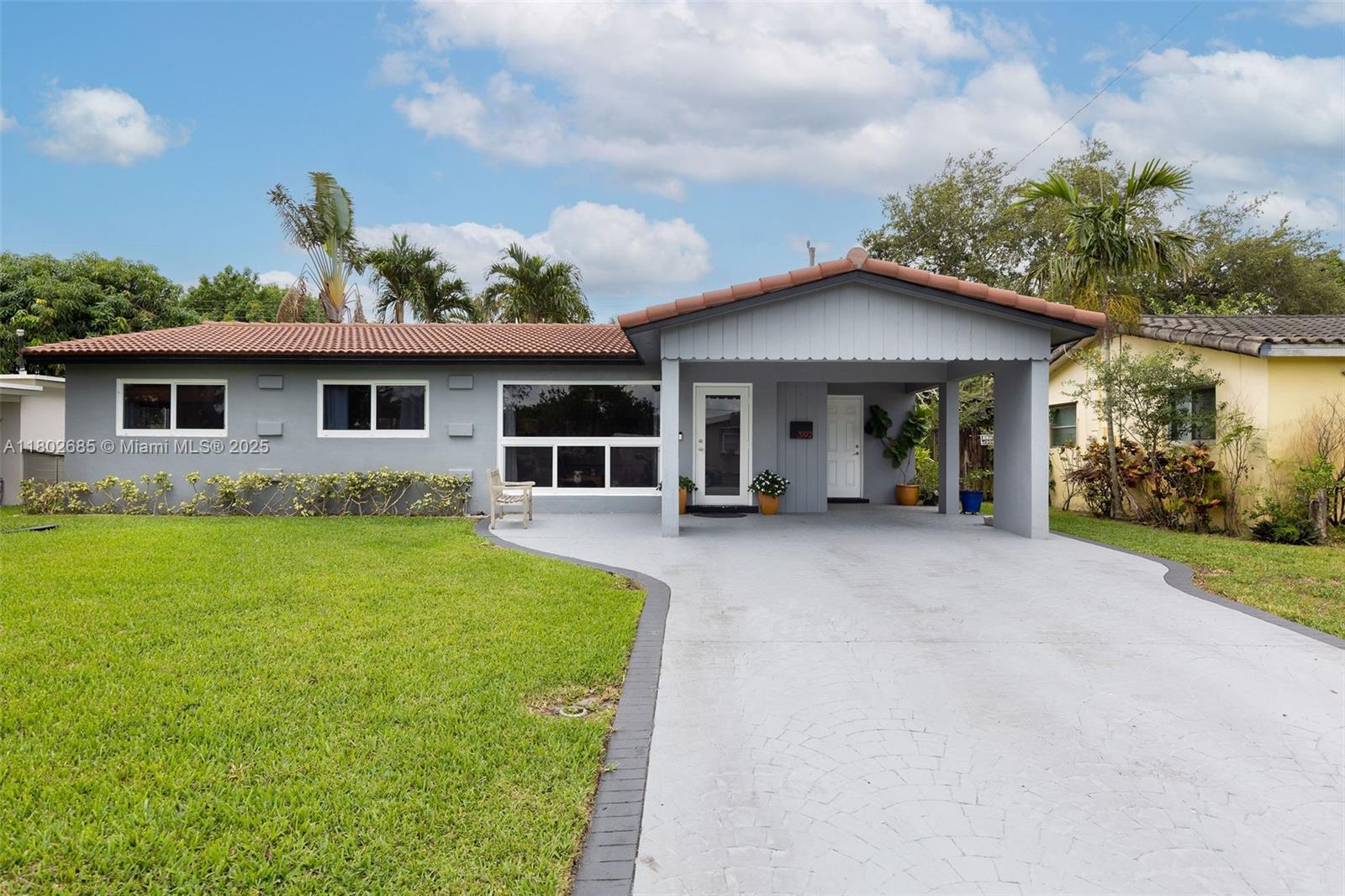 3192 Coolidge Street Hollywood, FL 33021 - Photo 26 of 34 a front view of a house with a garden and yard