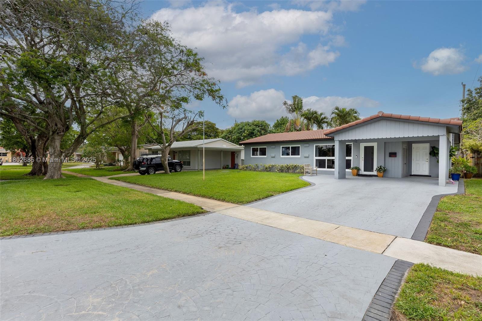 3192 Coolidge Street Hollywood, FL 33021 - Photo 29 of 34 a view of house in front of a big yard with large trees