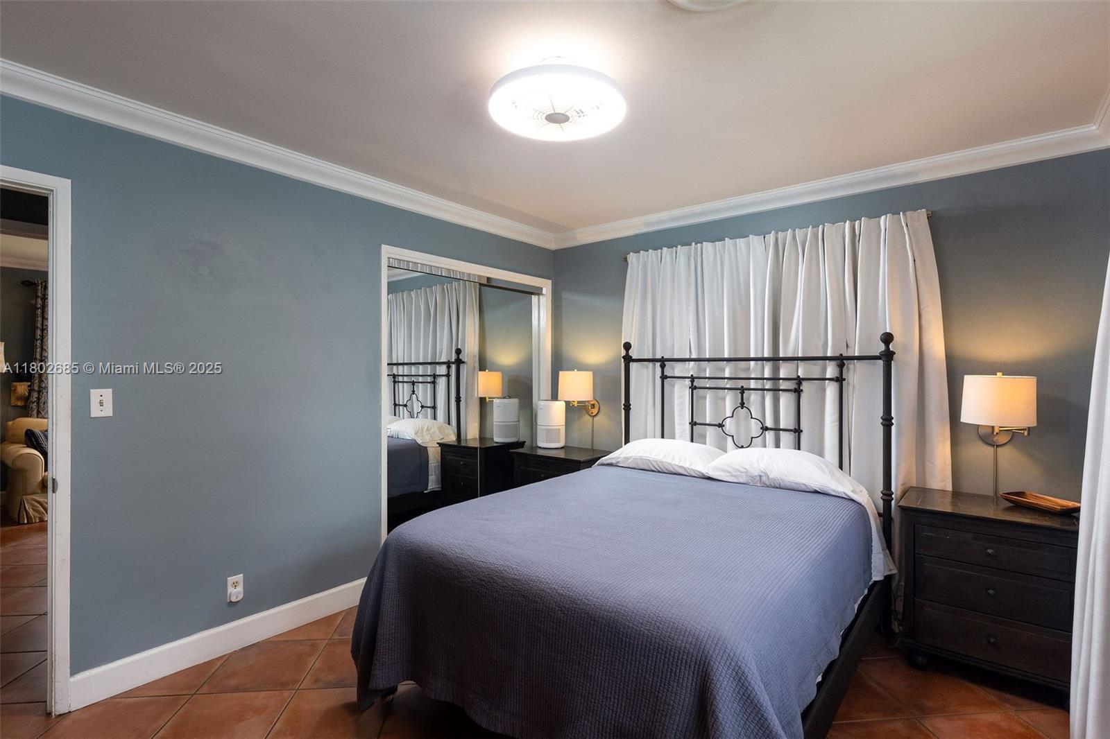 3192 Coolidge Street Hollywood, FL 33021 - Photo 5 of 34 a bedroom with a bed and a closet with mirror