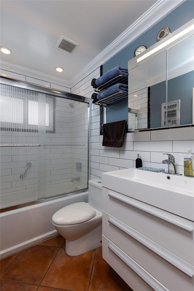 3192 Coolidge Street Hollywood, FL 33021 - Photo 7 of 34 a bathroom with a toilet a sink and mirror