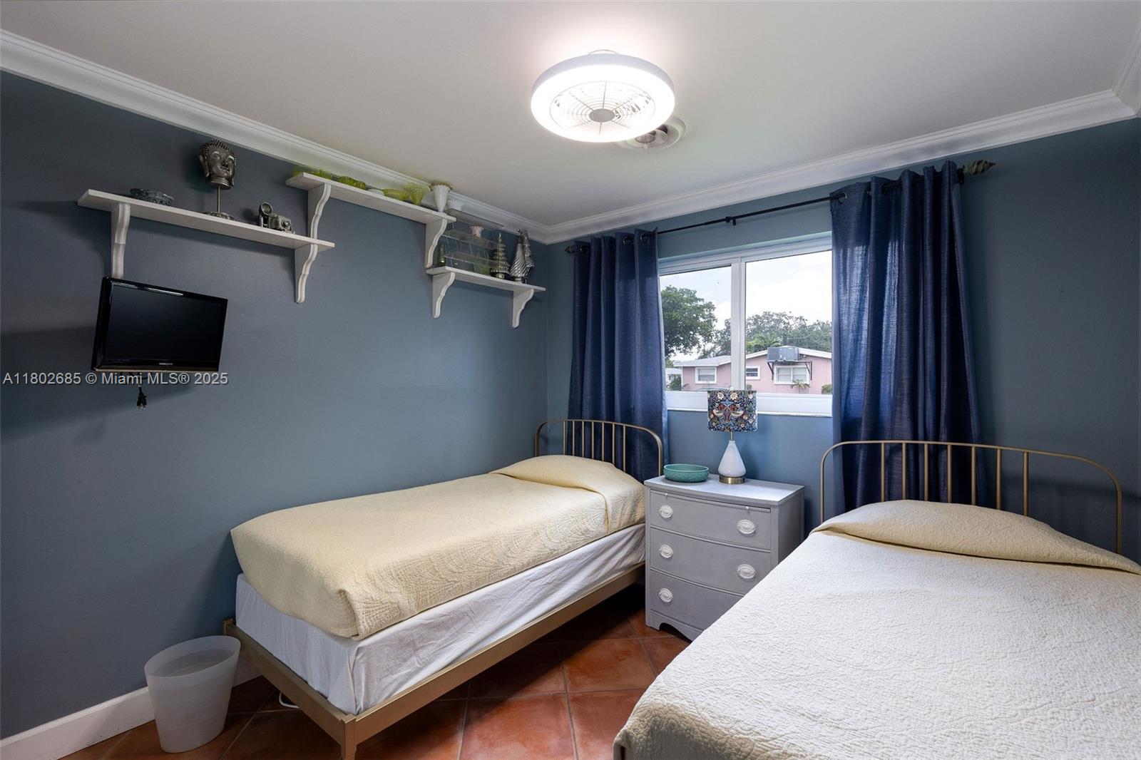 3192 Coolidge Street Hollywood, FL 33021 - Photo 10 of 34 a bedroom with a bed and a tv on the dresser