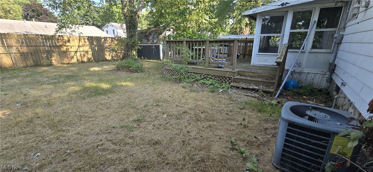 1943 Clyde Road Madison, OH 44057 - Photo 4 of 16 Fenced backyard with a wooden deck