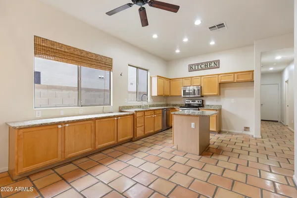 a large kitchen with kitchen island granite countertop a large counter top and appliances