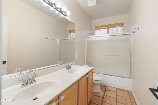 a view of a room with a window and ceiling fan