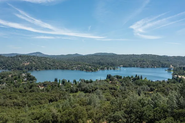 a view of a lake in middle of forest