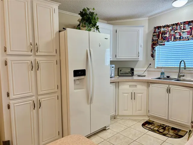 a white refrigerator freezer sitting inside of a kitchen