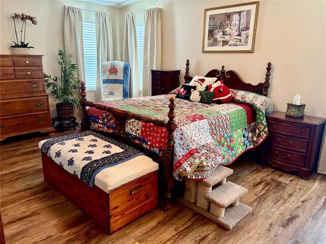 a bedroom with a bed and a painting on the wall