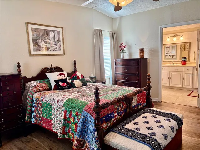 a bedroom with bed and wooden floor
