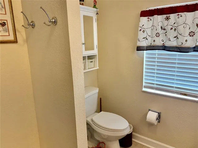 a bathroom with a toilet and a shower curtain