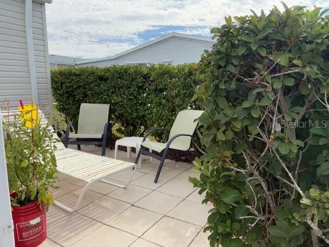 a view of a chairs and table in a backyard